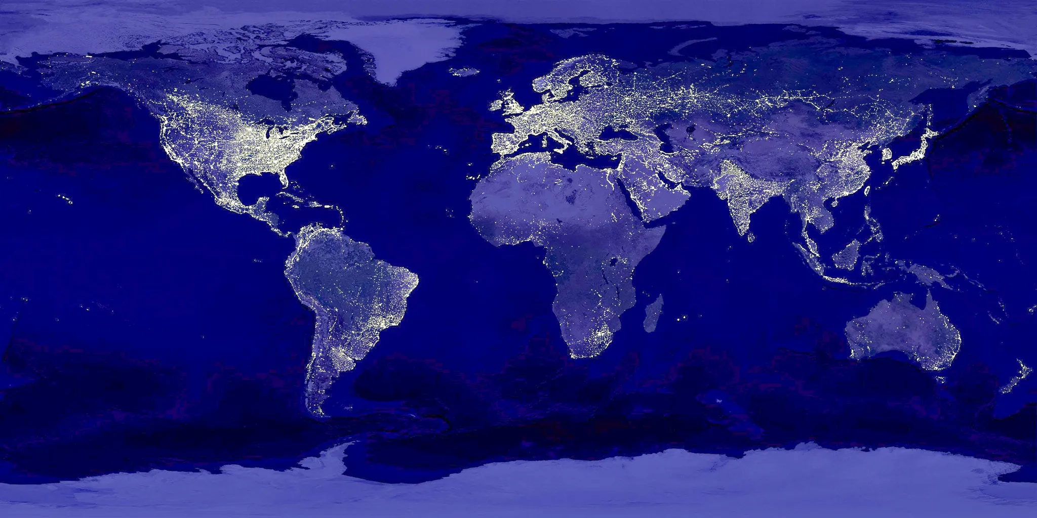 Earth at night from space, city lights glowing